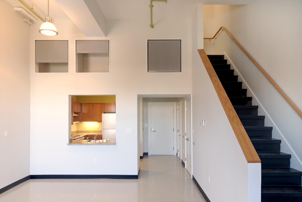 Unit interior with view into kitchen and stairway at side