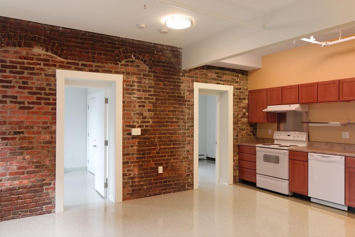Unit kitchen with preserved brick wall