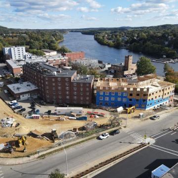 Bird's-eye view of Merrimack Place under construction with Merrimack River in background.